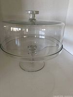 Overall view of glass pedestal cake stand with dome