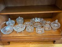 Entire 9-piece pressed glass set on shelf