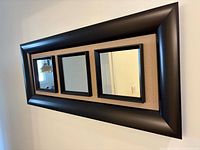 Front angled view showing full mirror, frame, and three glass panels