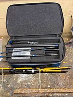 Overview of both rods, case open with rod sections and tackle box, Eagle Claw sections below