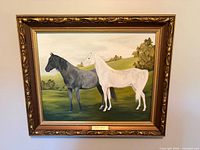 Full view of framed horse painting on wall