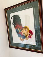 Full view of framed rooster embroidery showing frame, mat and artwork