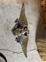 Full view of cast aluminum eagle plaque on floor