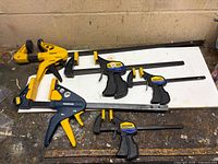 All clamps grouped on workbench showing types and sizes