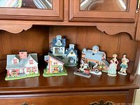 Front view of all porcelain village houses, carriage and figurines