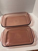 Both rectangular purple glass Pyrex dishes top view