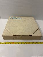 Closed Reco cardboard box with tape measure for scale