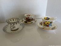 Three Royal Albert teacup and saucer sets displayed together