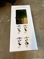Retail box front showing solar decor garden stake variants