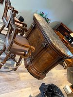 Front view of marble-top bar with two matching stools