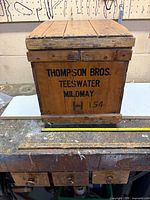 Front view showing Thompson Bros. branding and metal latch