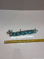 Bracelet laid flat beside tape measure showing 7-inch length