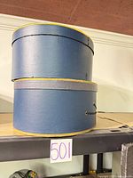Stacked blue round hat boxes on shelf