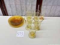 Amber glass goblets stacked, shallow bowls stacked, one tall glass