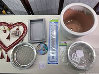 Overview of planter, sieves, thermometer, stones, ornament