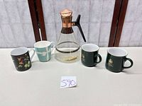 Full lot view showing carafe and four mugs