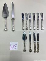 Full set of 12 Gorham stainless steel serving utensils and flatware pieces laid out for count and pattern visibility