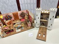 overall view of yarn shop diorama and castle tower gate diorama side by side