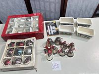 Full lot: two boxes of glass ornaments, six metal bells, four ceramic loaf pans, LED candle package