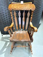 Front view showing painted crest, spindles, seat and legs