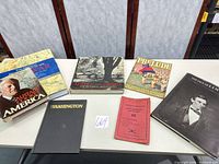 All seven listed books arranged on table