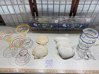 Group shot showing pitcher, glasses, seashells and two boxed string light sets