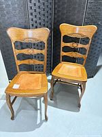 Front view showing both oak dining chairs