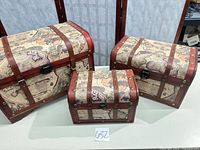 All three wooden map-print trunks grouped together
