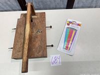 Top view of wooden book press clamp showing handle, screws, and maker plate