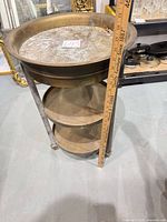 Full view of 3-tier brass cart with ruler showing height
