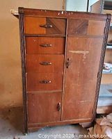 Front view of tall dresser showing drawers, wardrobe door and veneer patterns