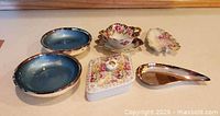 all six decorative porcelain pieces arranged on surface
