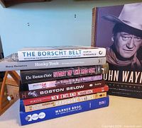Stack of hardcover books showing titles and spine details
