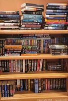 Full view of bookcase with books on three shelves