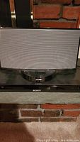 Front view of speaker dock sitting atop DVD player
