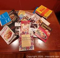 Group of cookbooks spread on table
