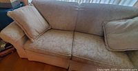 Left side close-up of sofa seat, arm, and pillow