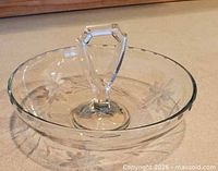 Top view showing floral etching and central faceted handle
