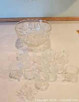 Punch bowl with cups arranged around it