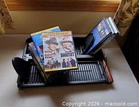 DVD stand with several DVD cases including John Wayne double feature visible