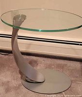 Full view of glass top side table with metal base