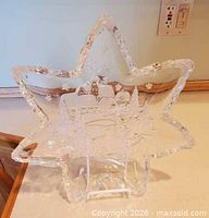 Front view of star-shaped glass dish on stand showing winter scene detail