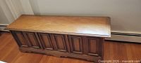 Closed chest showing oak veneer exterior and paneled front