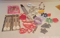 Overall view of all cookie cutters, thermometer and measuring spoons on countertop