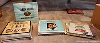 Three stacks of LPs with Glenn Miller cover displayed upright