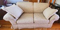 Front view of love seat with two pillows