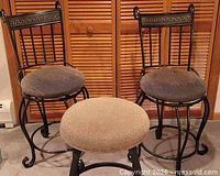 Two ornate-back metal bar stools and one backless stool showing overall style and cushions