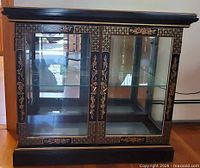 Frontal view showing cabinet doors, shelves, decorative trim