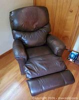 Front view reclined showing leather upholstery and footrest