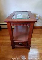 front and side view of solid wood end table showing glass top, shelf and drawer